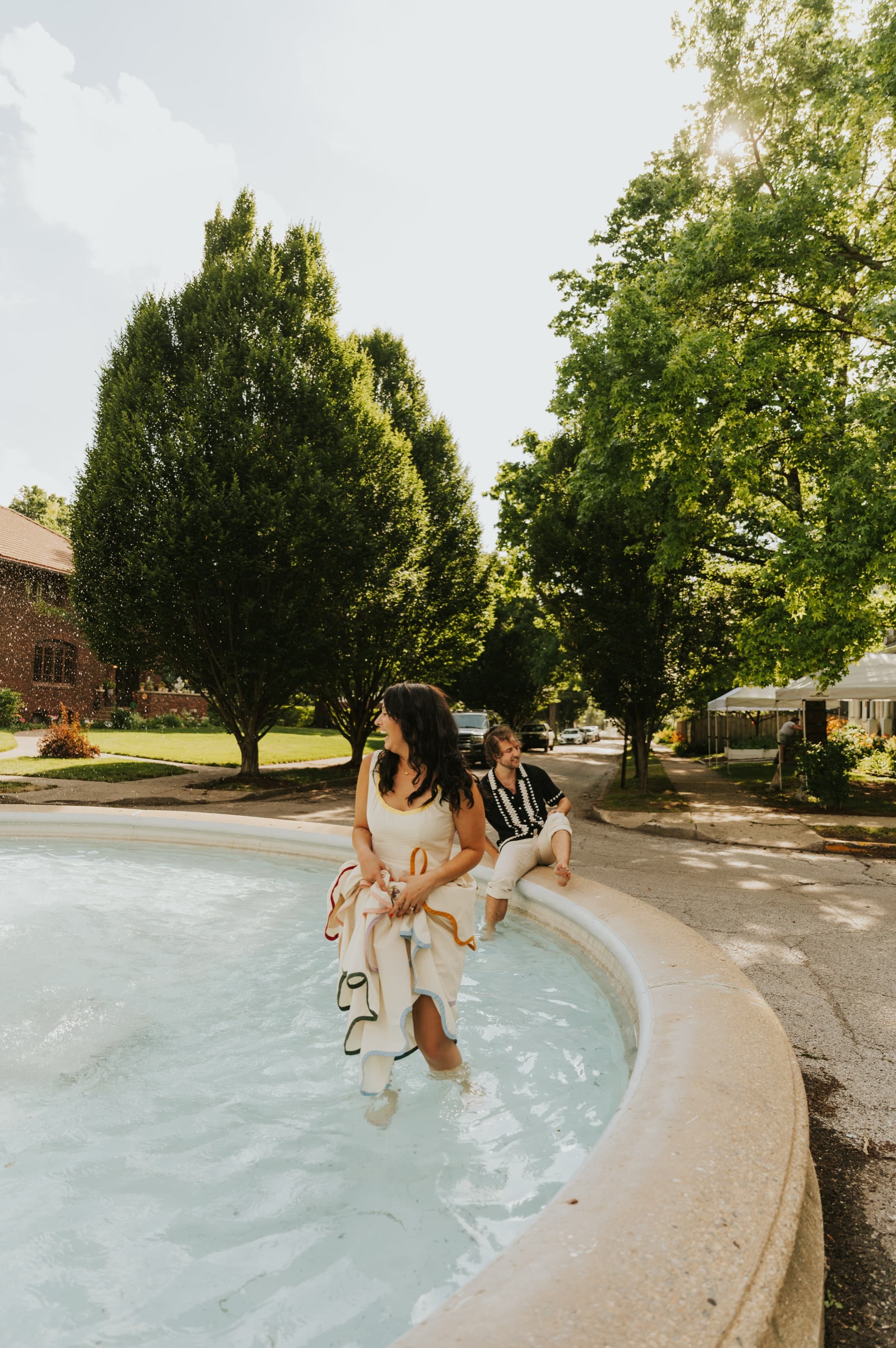 Derek and Shannon sitting on the edge of a pool