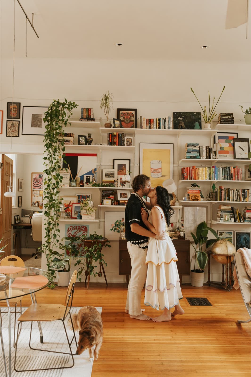 Derek and Shannon kissing in a plant-filled living room