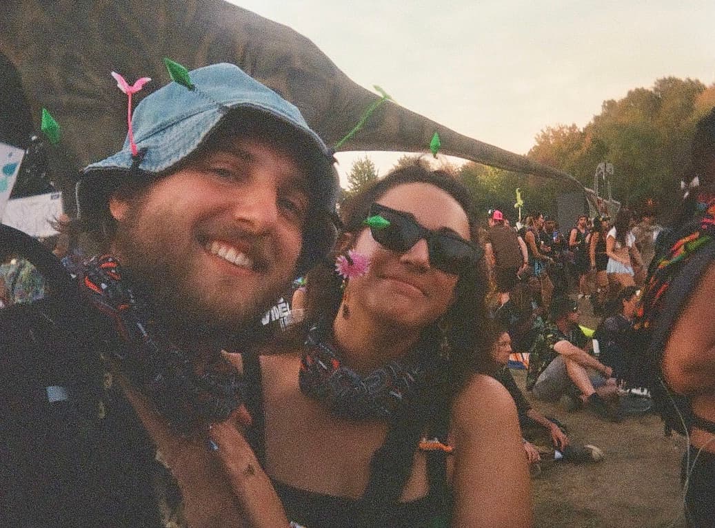 Derek and Shannon cheek to cheek at a festival at sunset